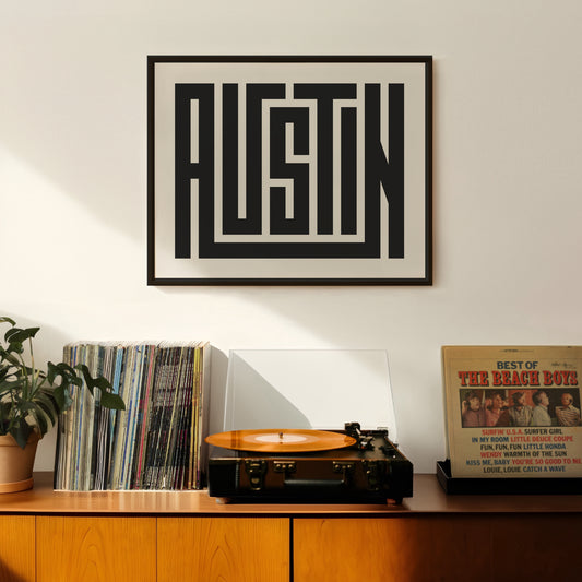 Retro Austin artwork above vintage record player on Mid-Century Modern furniture.