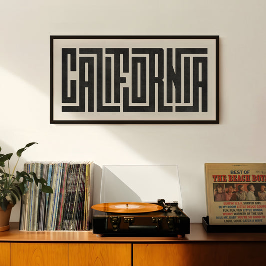 Retro California artwork above vintage record player on Mid-Century Modern furniture.