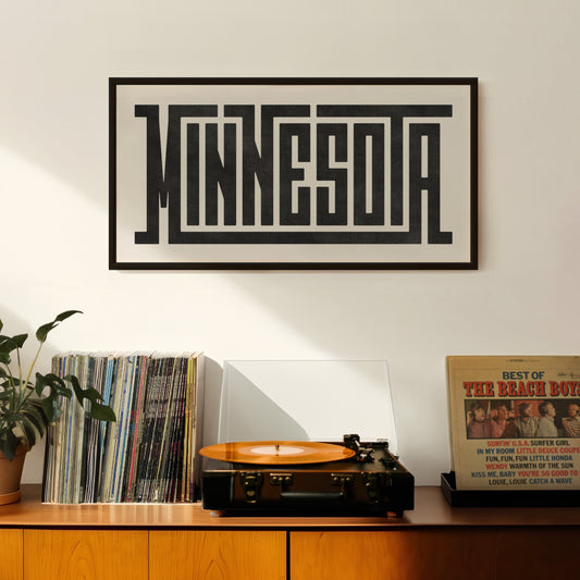 Retro Minnesota artwork above vintage record player on Mid-Century Modern furniture.