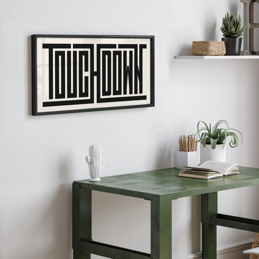 Personalized Touchdown poster in Black Frame above desk in minimalist dorm room.