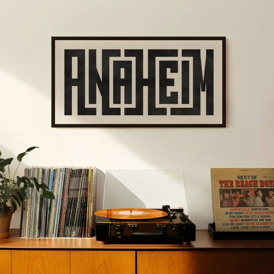 Retro Anaheim artwork above vintage record player on Mid-Century Modern furniture.