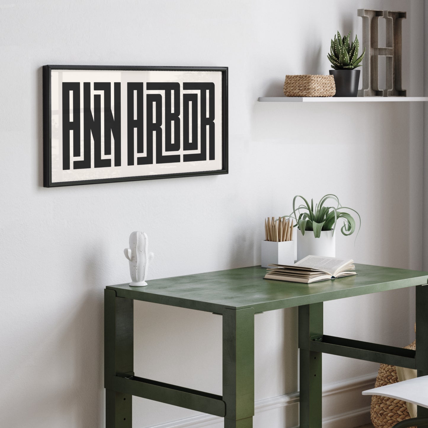 Personalized Ann Arbor art poster in Black Frame above desk in minimalist dorm room.
