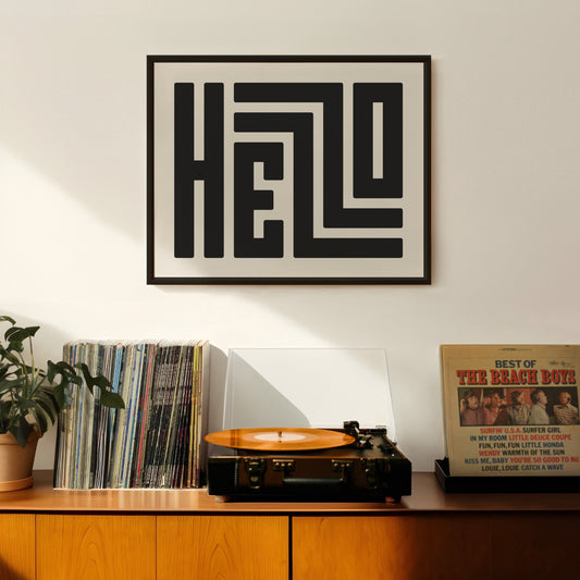 Retro Hello artwork above vintage record player on Mid-Century Modern furniture.