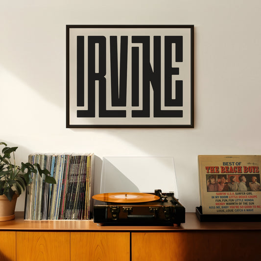 Retro Irvine artwork above vintage record player on Mid-Century Modern furniture.
