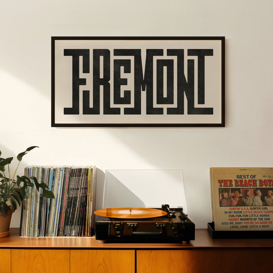 Retro Fremont artwork above vintage record player on Mid-Century Modern furniture.