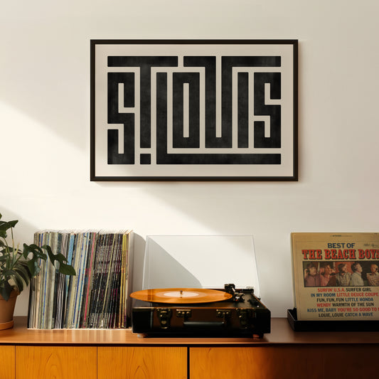 Retro St. Louis artwork above vintage record player on Mid-Century Modern furniture.