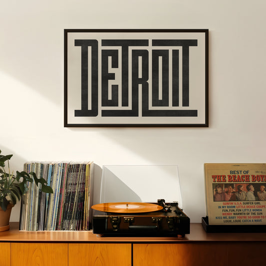 Retro Detroit artwork above vintage record player on Mid-Century Modern furniture.