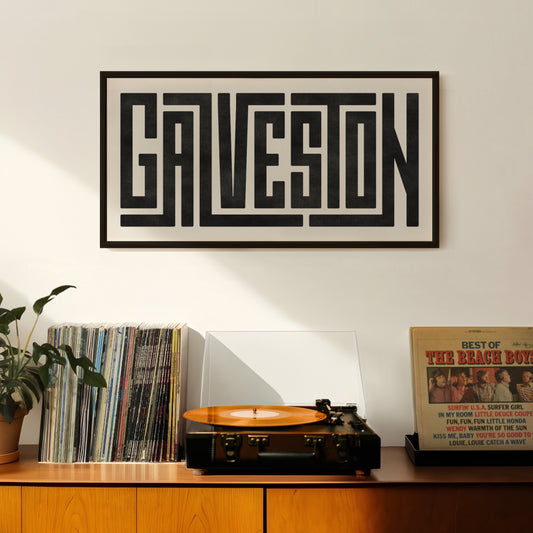 Retro Galveston artwork above vintage record player on Mid-Century Modern furniture.
