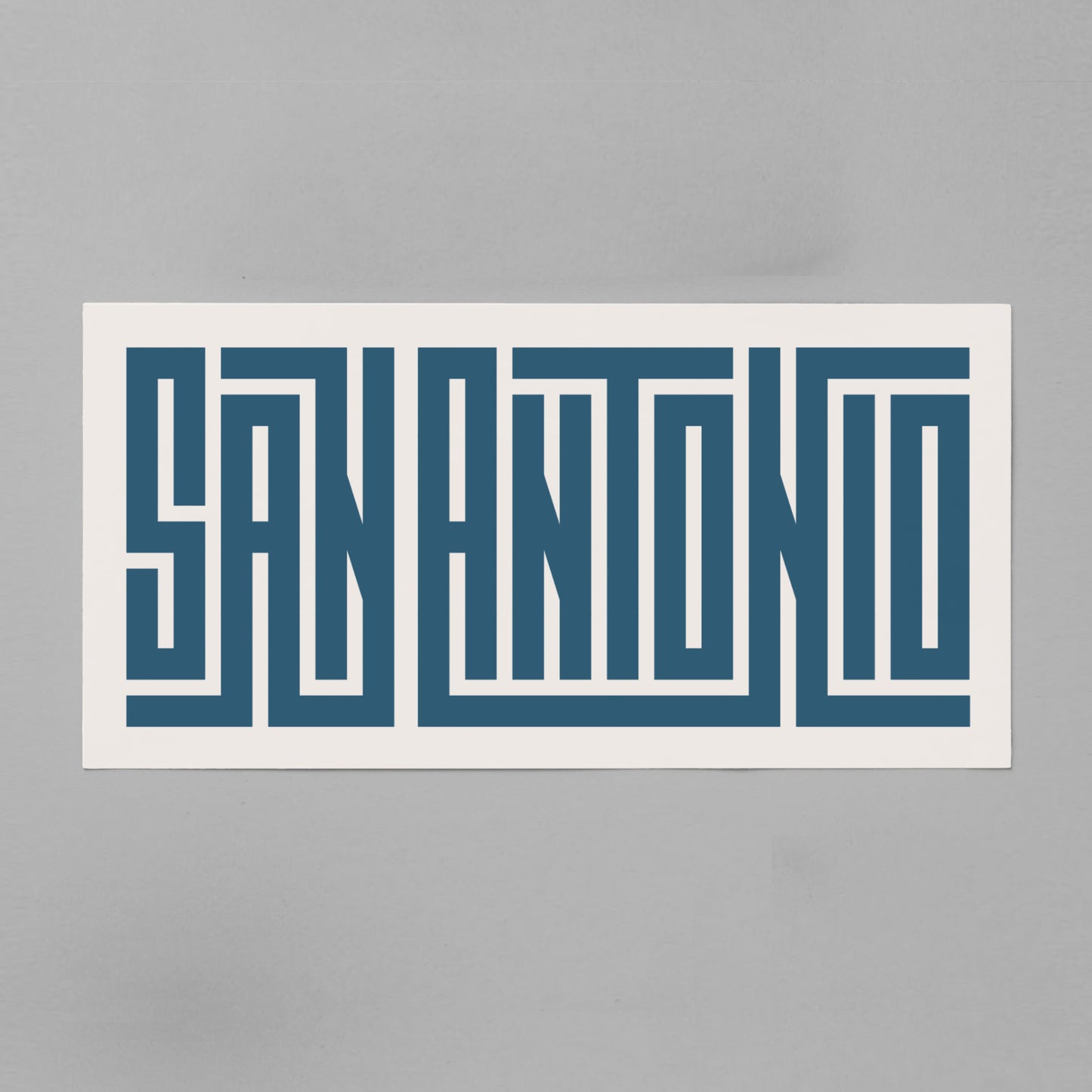 Personalized San Antonio poster in Black Frame above desk in minimalist dorm room.