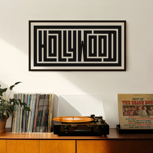 Retro Hollywood artwork above vintage record player on Mid-Century Modern furniture.