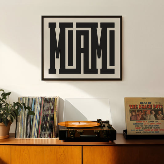 Retro Miami artwork above vintage record player on Mid-Century Modern furniture.