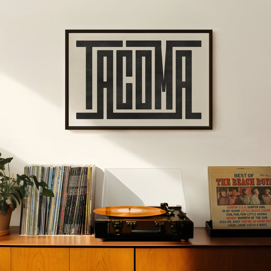 Retro Tacoma artwork above vintage record player on Mid-Century Modern furniture.