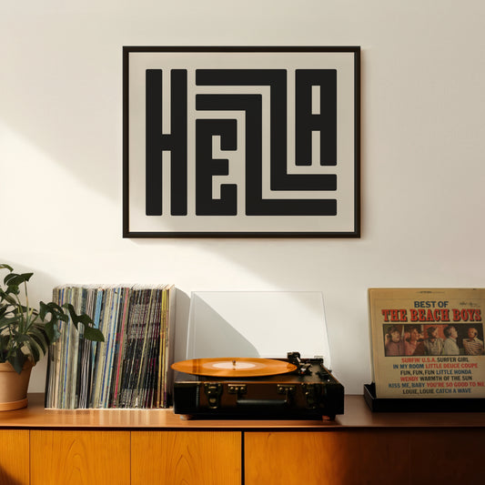 Retro Hella artwork above vintage record player on Mid-Century Modern furniture.