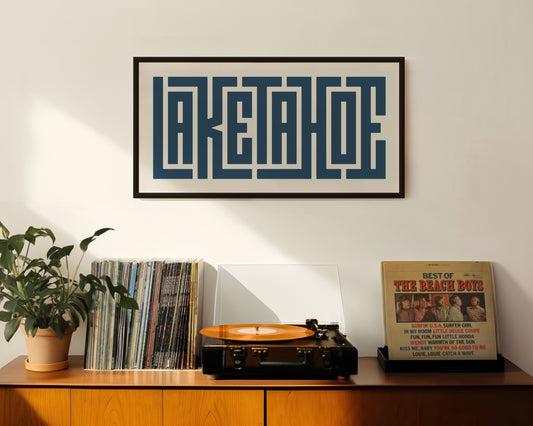 Retro Lake Tahoe artwork above vintage record player on Mid-Century Modern furniture.