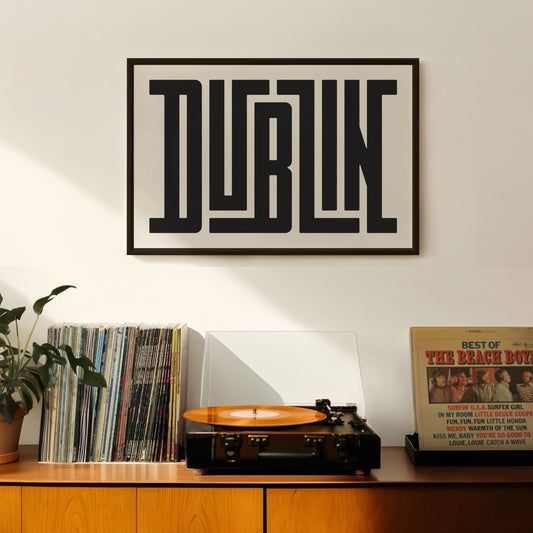Retro Dublin artwork above vintage record player on Mid-Century Modern furniture.