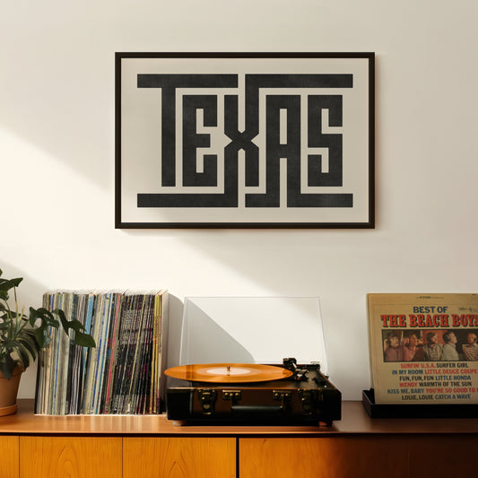 Retro Texas artwork above vintage record player on Mid-Century Modern furniture.