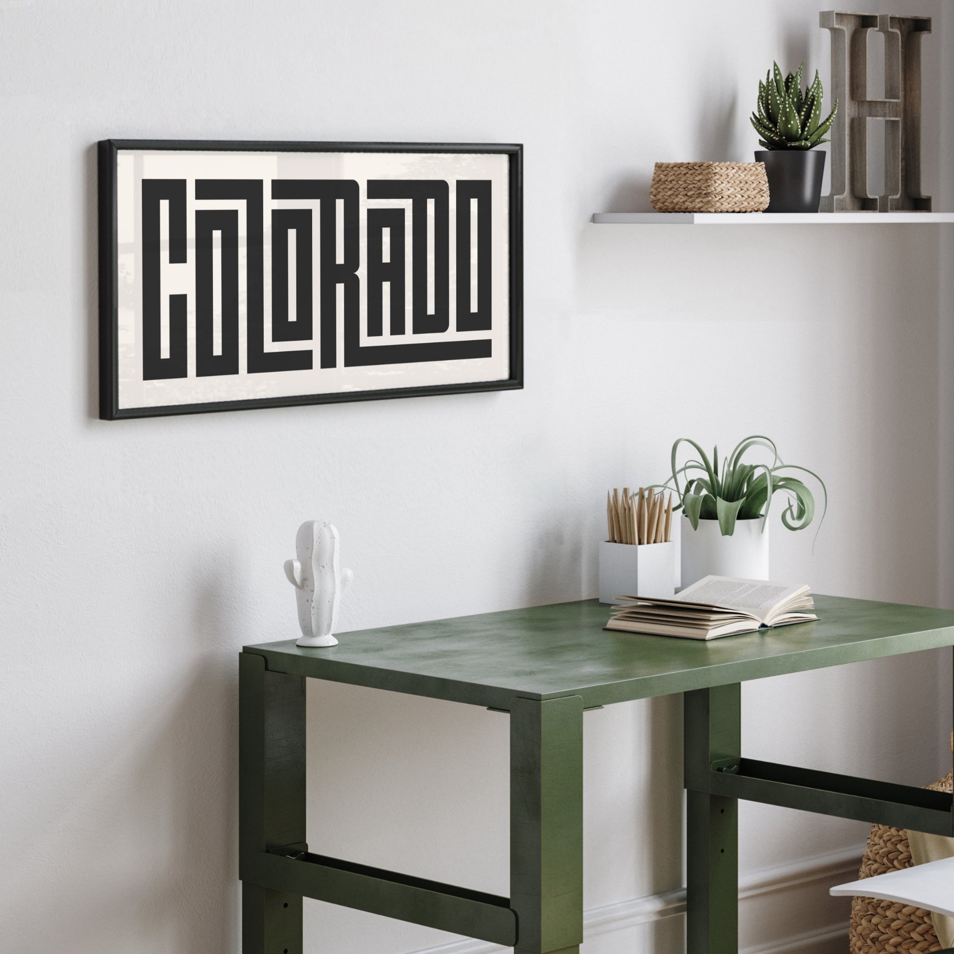Personalized Colorado art poster in Black Frame above desk in minimalist dorm room.