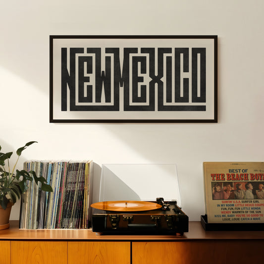 Retro New Mexico artwork above vintage record player on Mid-Century Modern furniture.