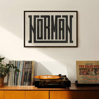 Retro Norman artwork above vintage record player on Mid-Century Modern furniture.
