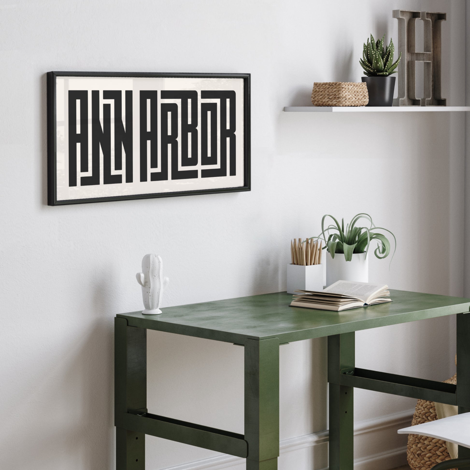 Personalized Ann Arbor art poster in Black Frame above desk in minimalist dorm room.