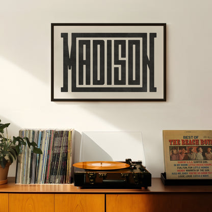 Retro Madison artwork above vintage record player on Mid-Century Modern furniture.