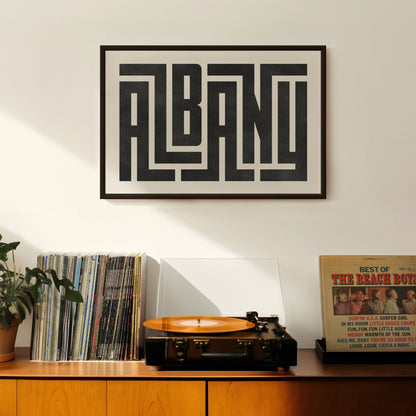 Retro Albany artwork above vintage record player on Mid-Century Modern furniture.