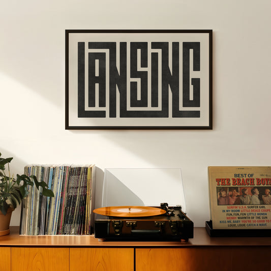 Retro Lansing artwork above vintage record player on Mid-Century Modern furniture.