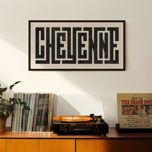 Retro Cheyenne artwork above vintage record player on Mid-Century Modern furniture.