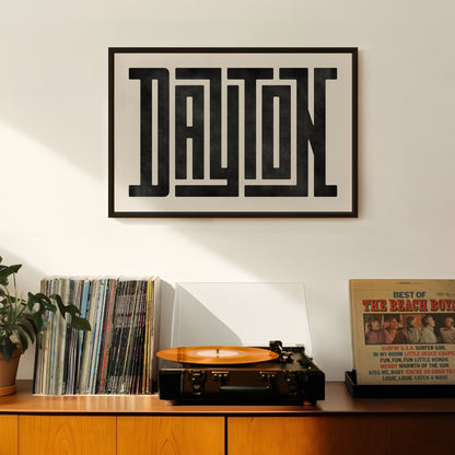 Retro Dayton artwork above vintage record player on Mid-Century Modern furniture.