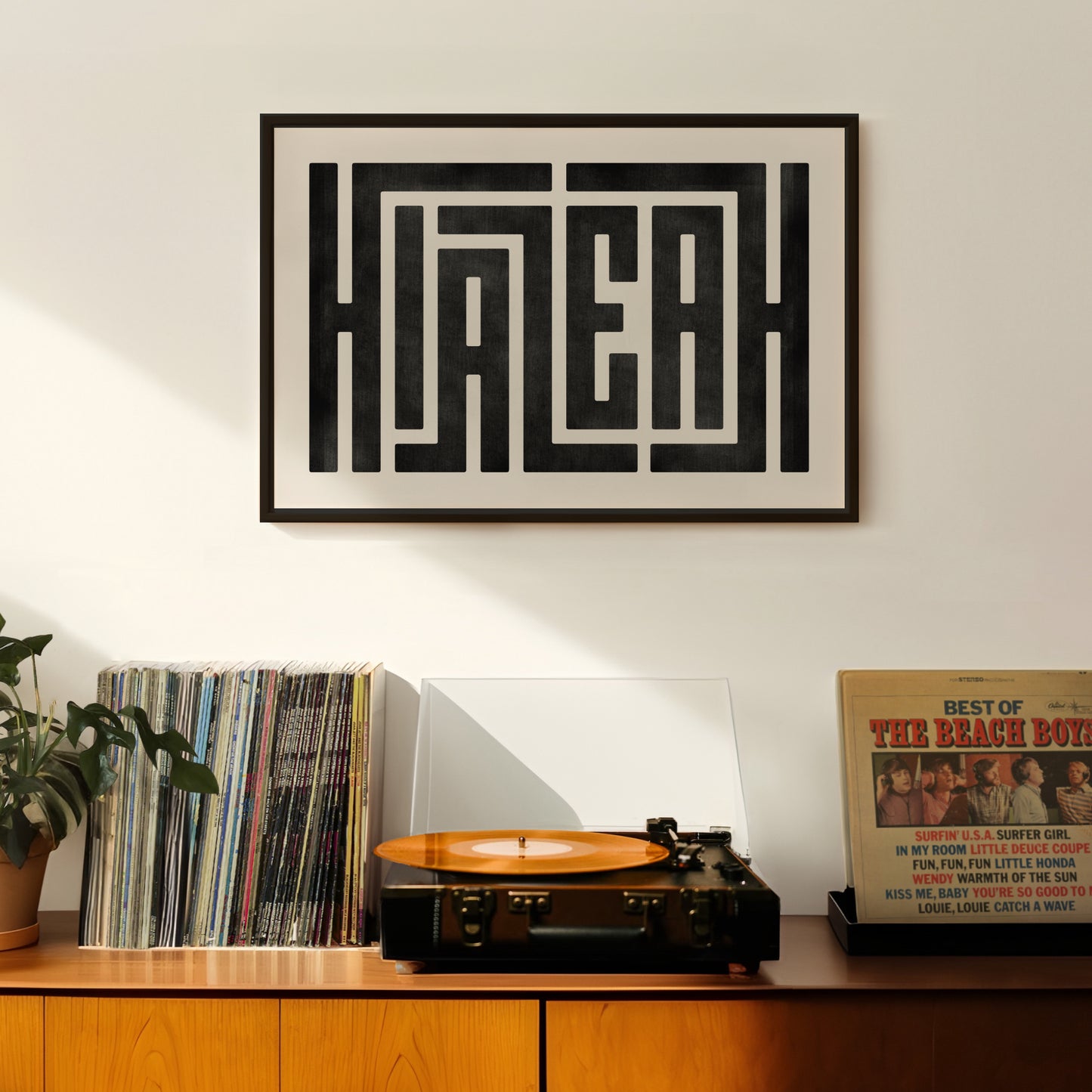 Retro Hialeah artwork above vintage record player on Mid-Century Modern furniture.