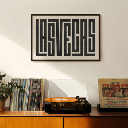 Retro Las Vegas artwork above vintage record player on Mid-Century Modern furniture.