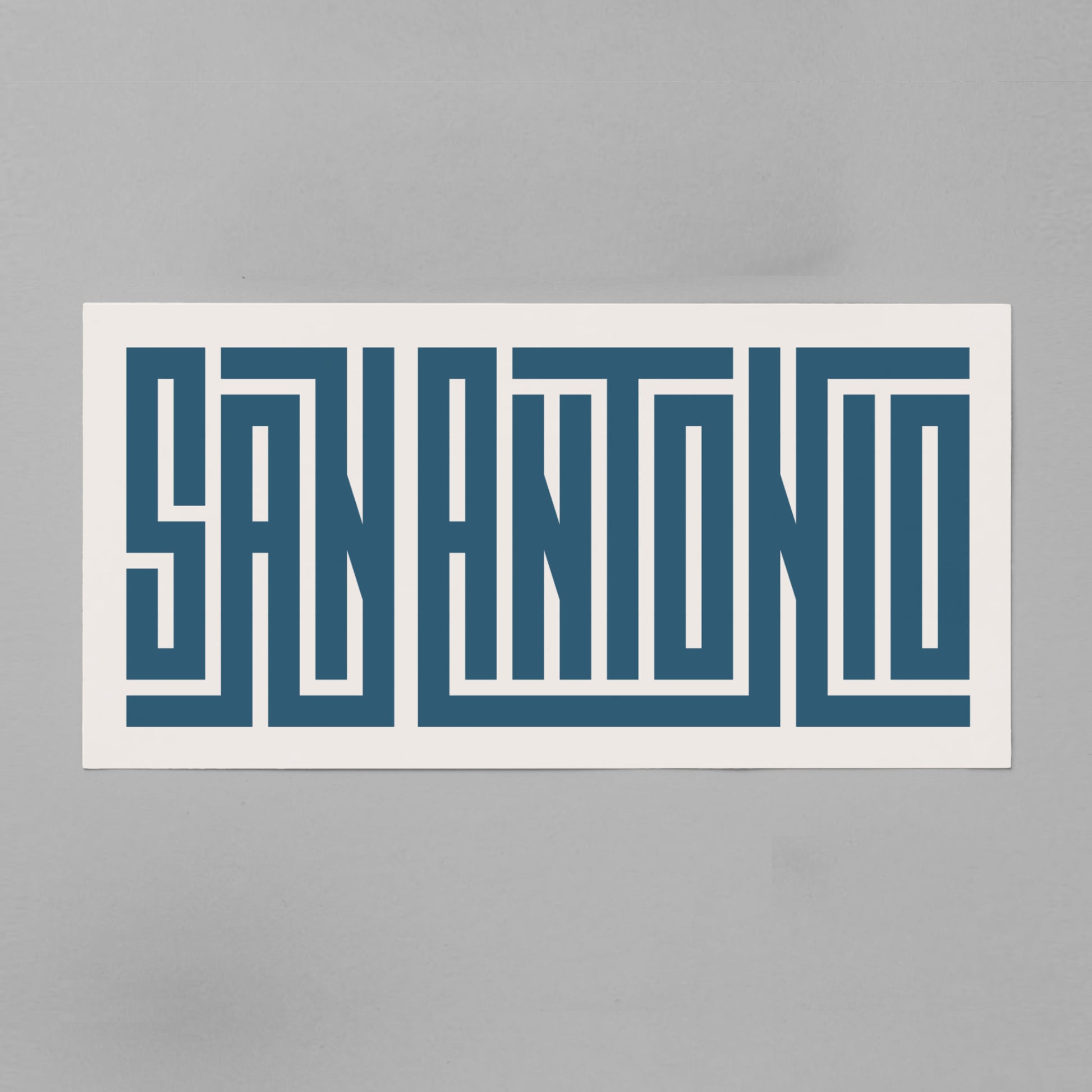 Personalized San Antonio poster in Black Frame above desk in minimalist dorm room.