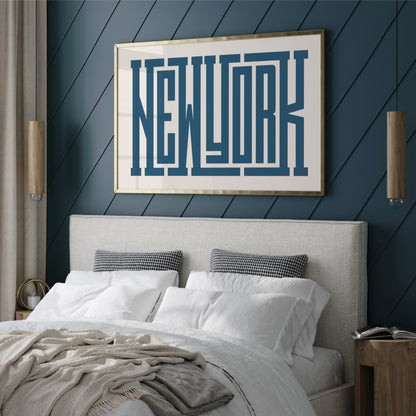 Hotel Bedroom with 'New York' framed artwork on a blue paneled wall.