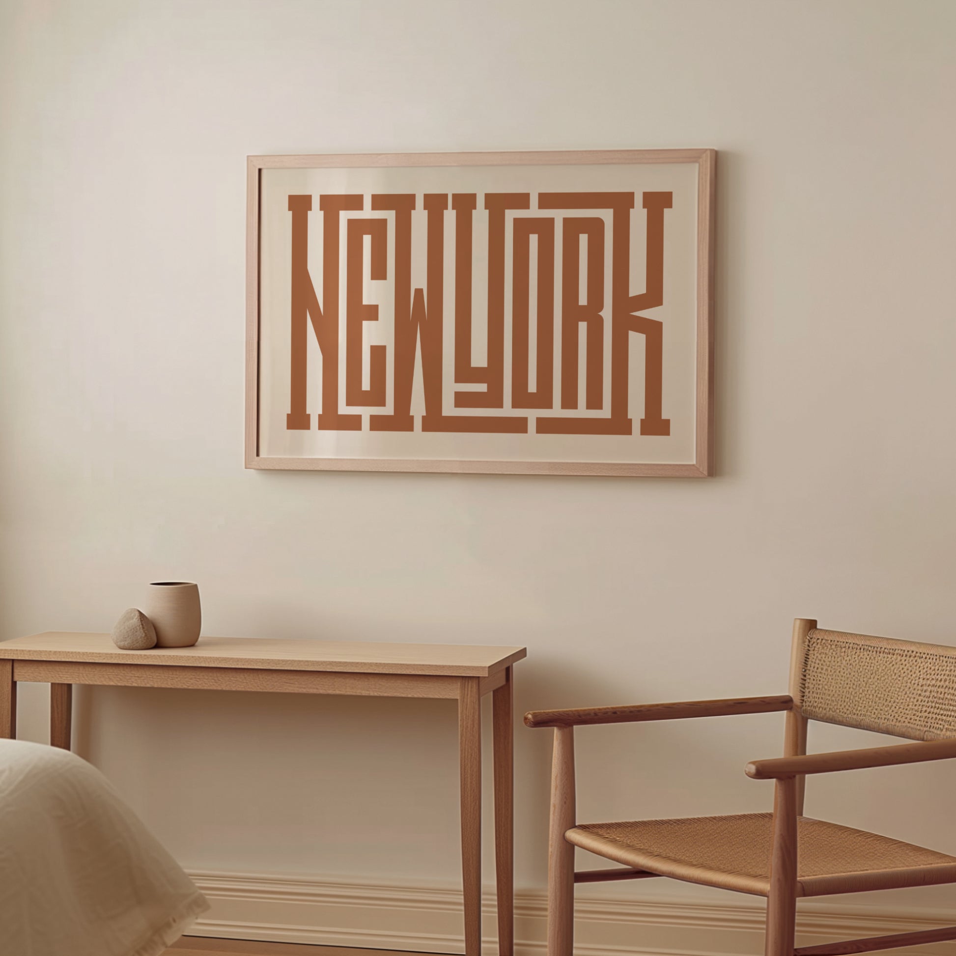 Boho Framed artwork with 'New York' on a wall above a wooden table and chair.