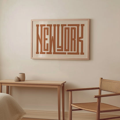 Boho Framed artwork with 'New York' on a wall above a wooden table and chair.