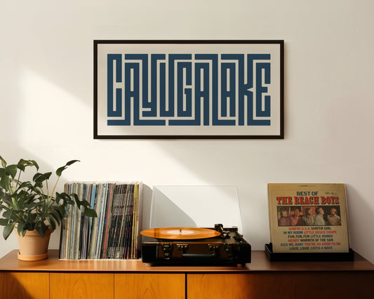 Retro Cayuga Lake artwork above vintage record player on Mid-Century Modern furniture.