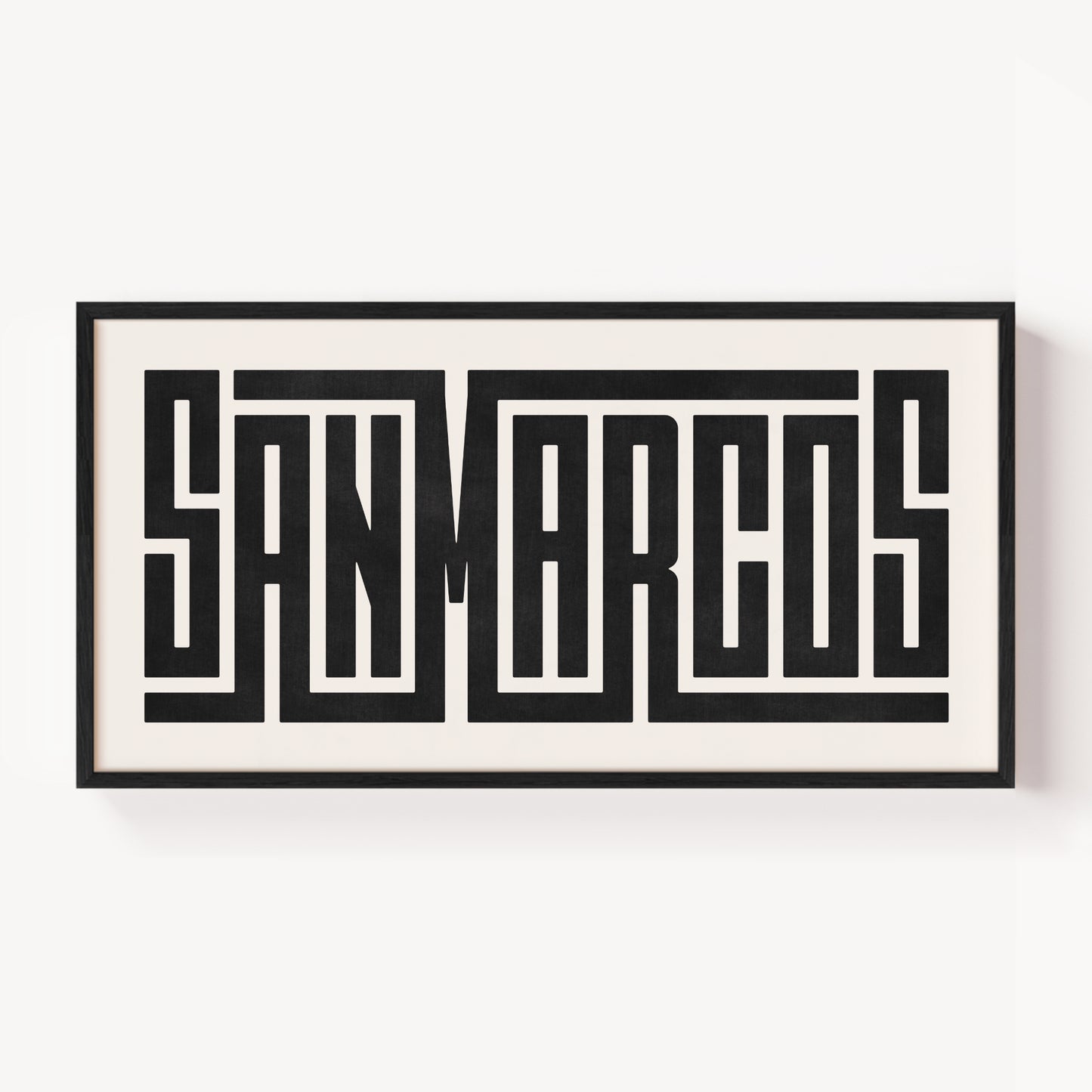 Framed artwork with 'SAN MARCOS' text on a white background