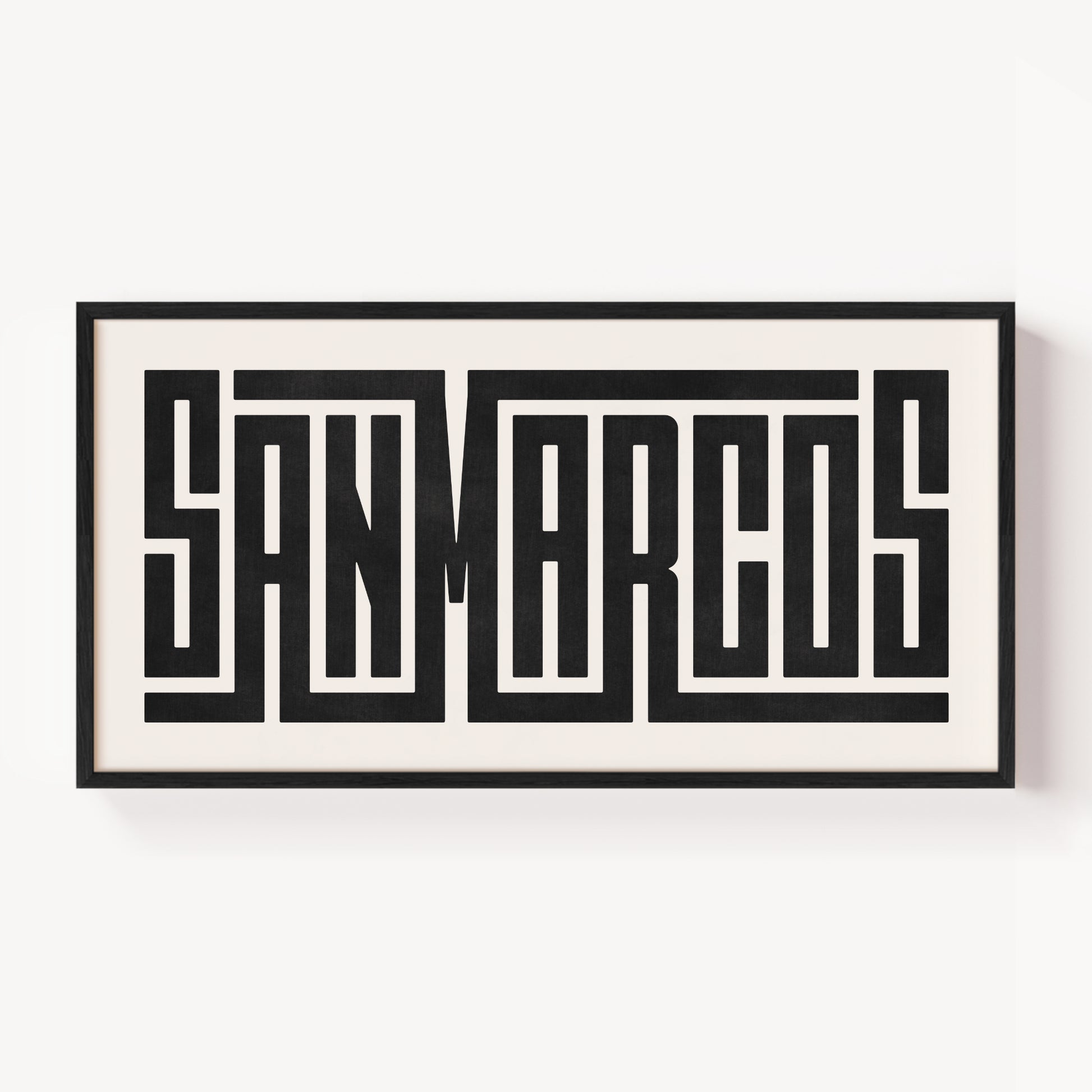 Framed artwork with 'SAN MARCOS' text on a white background